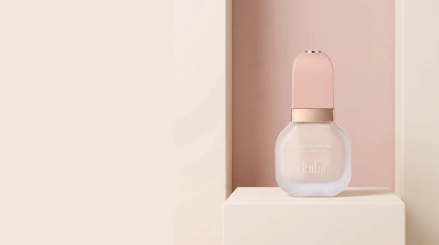 Kulio foundation on an ivory podium against a soft pink background
